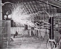 Publicity photo of Tesla sitting in his laboratory in Colorado Springs